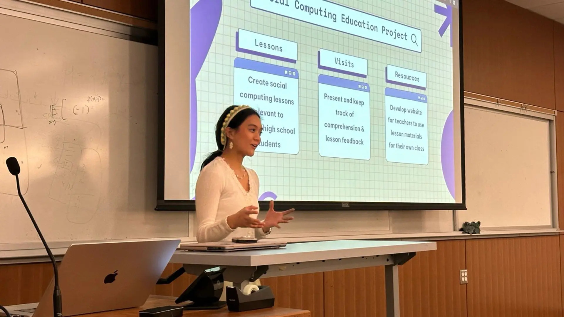 Presenter in the midst of discussing their research