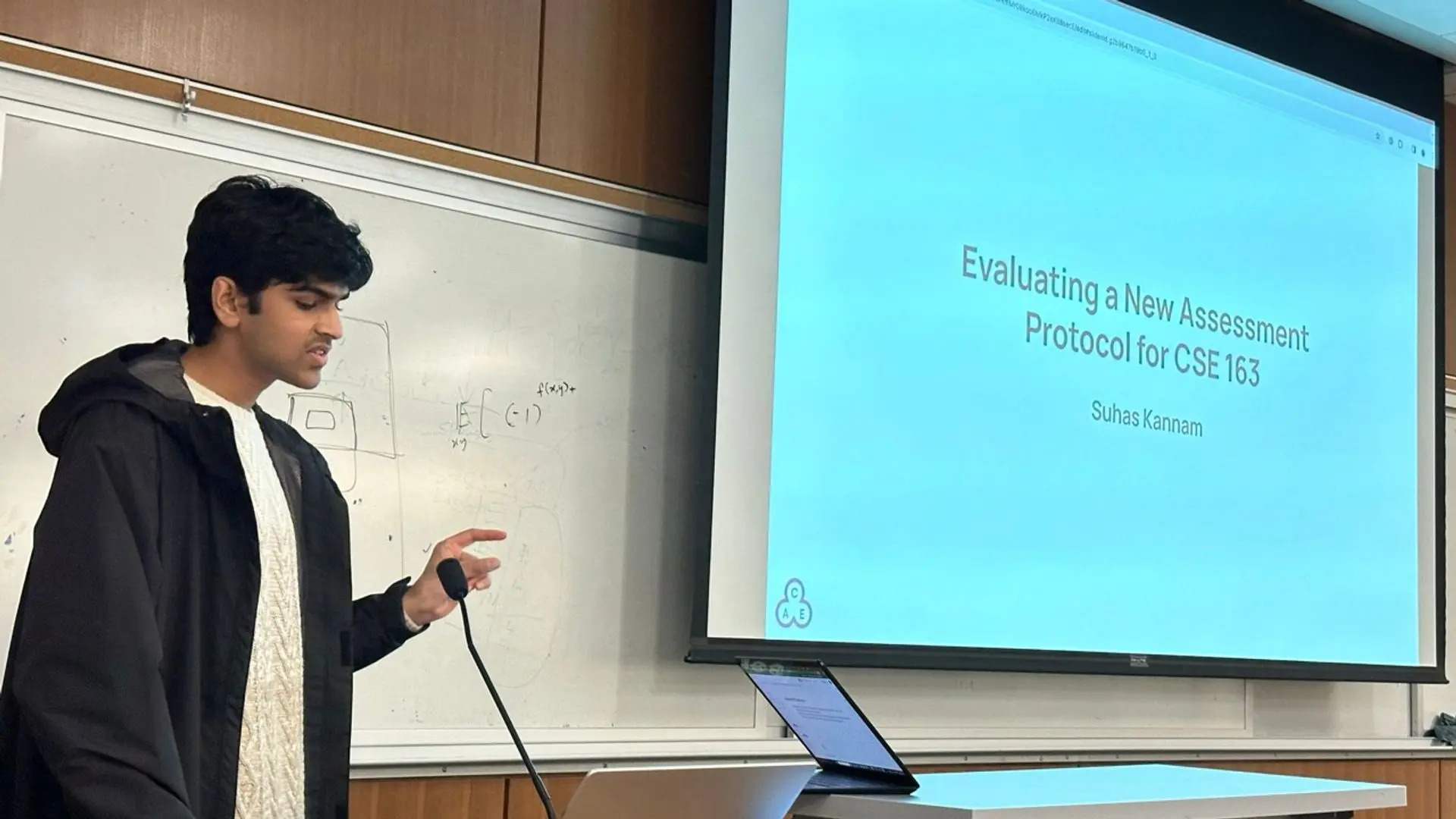 Presenter in the midst of discussing their research