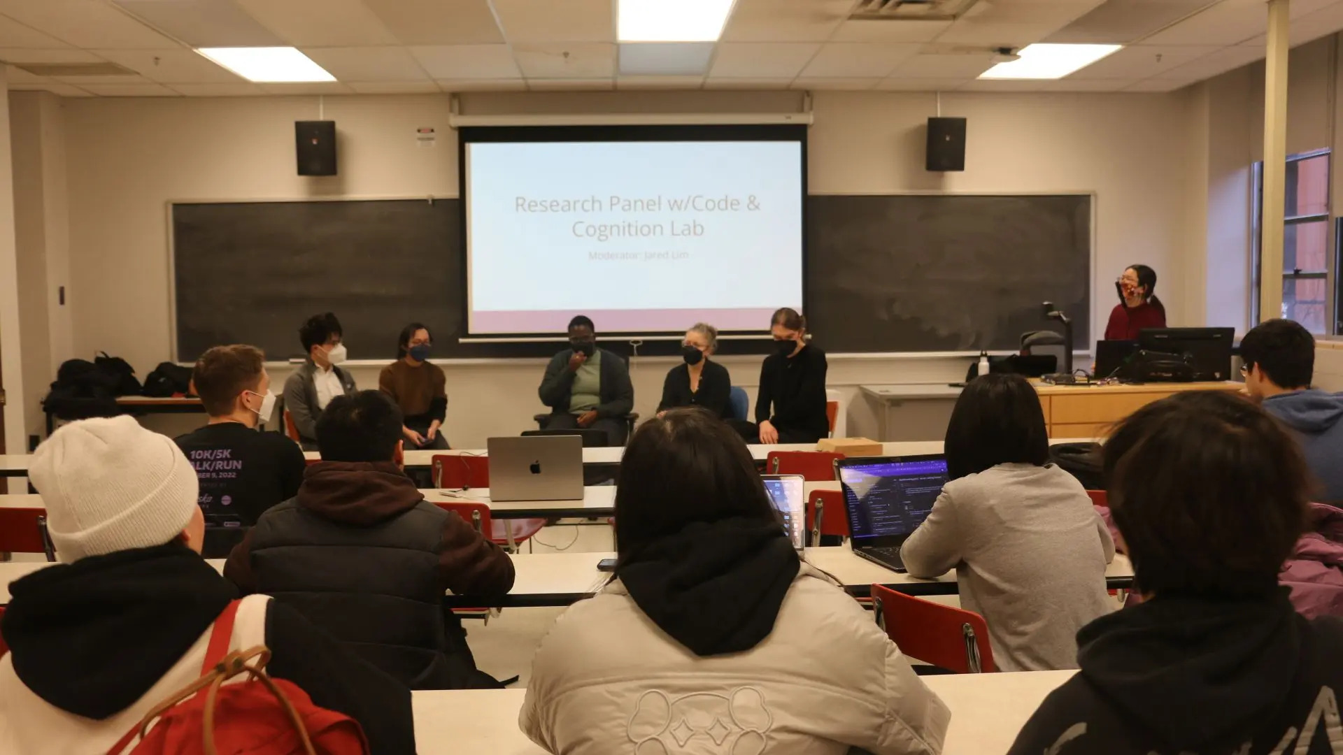 Students watching UW researchers presenting their work in computing education research