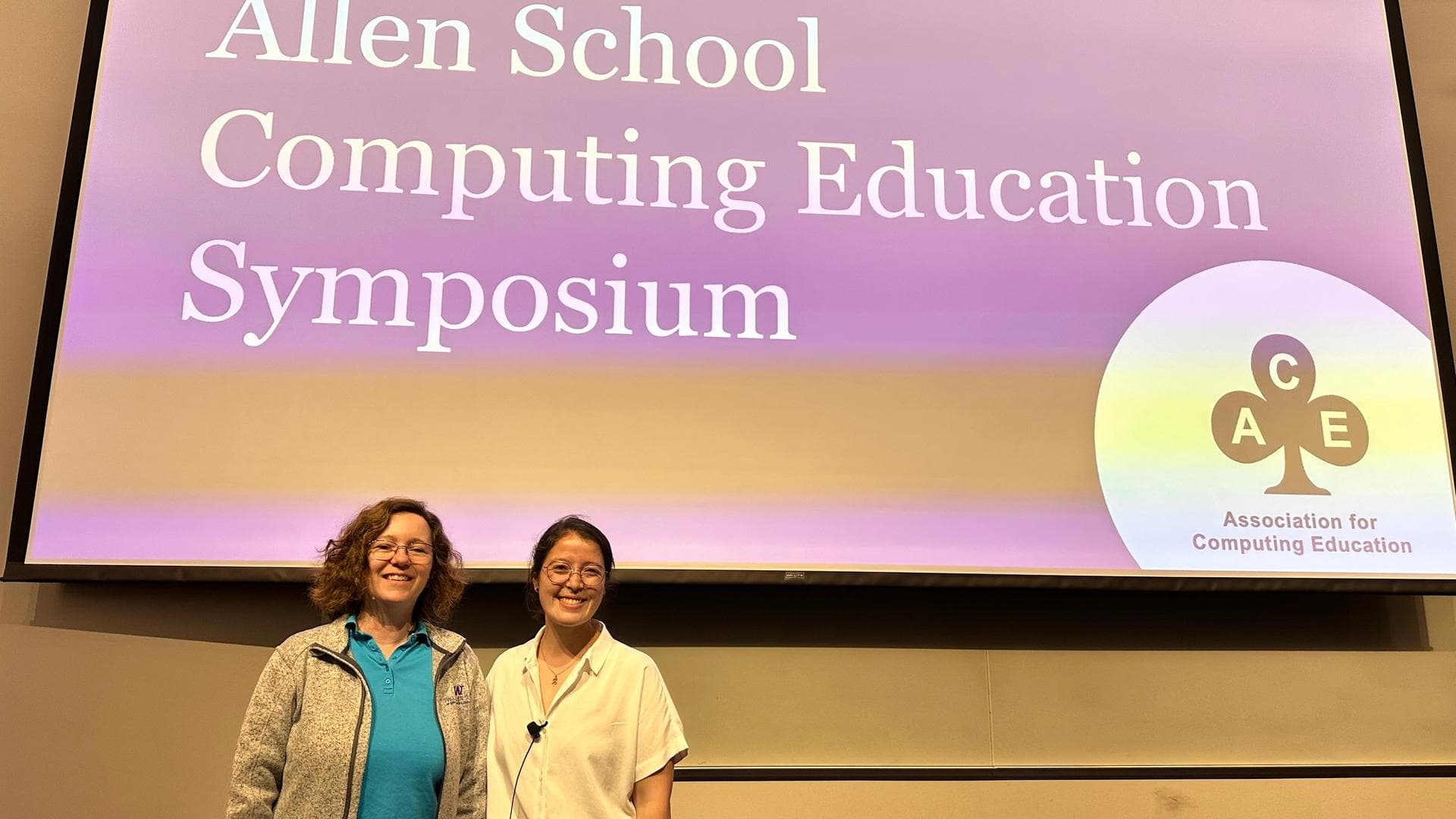 Magda and Miya in front of the screen with the keynote presentation title slide