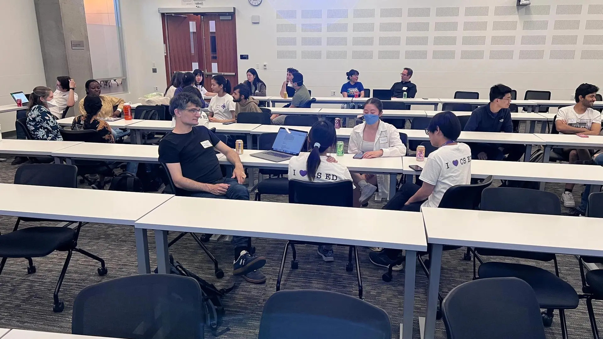 Students and faculty engaged in conversation during the symposium