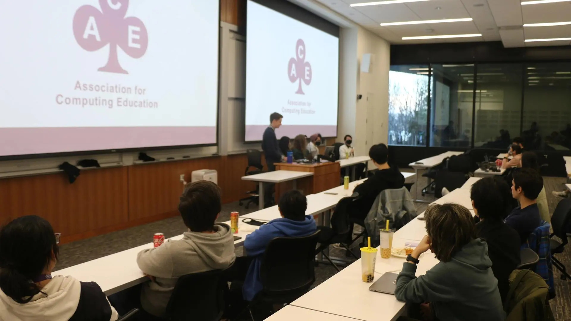 Lots of students listening to the panel of 4 TAs answering questions