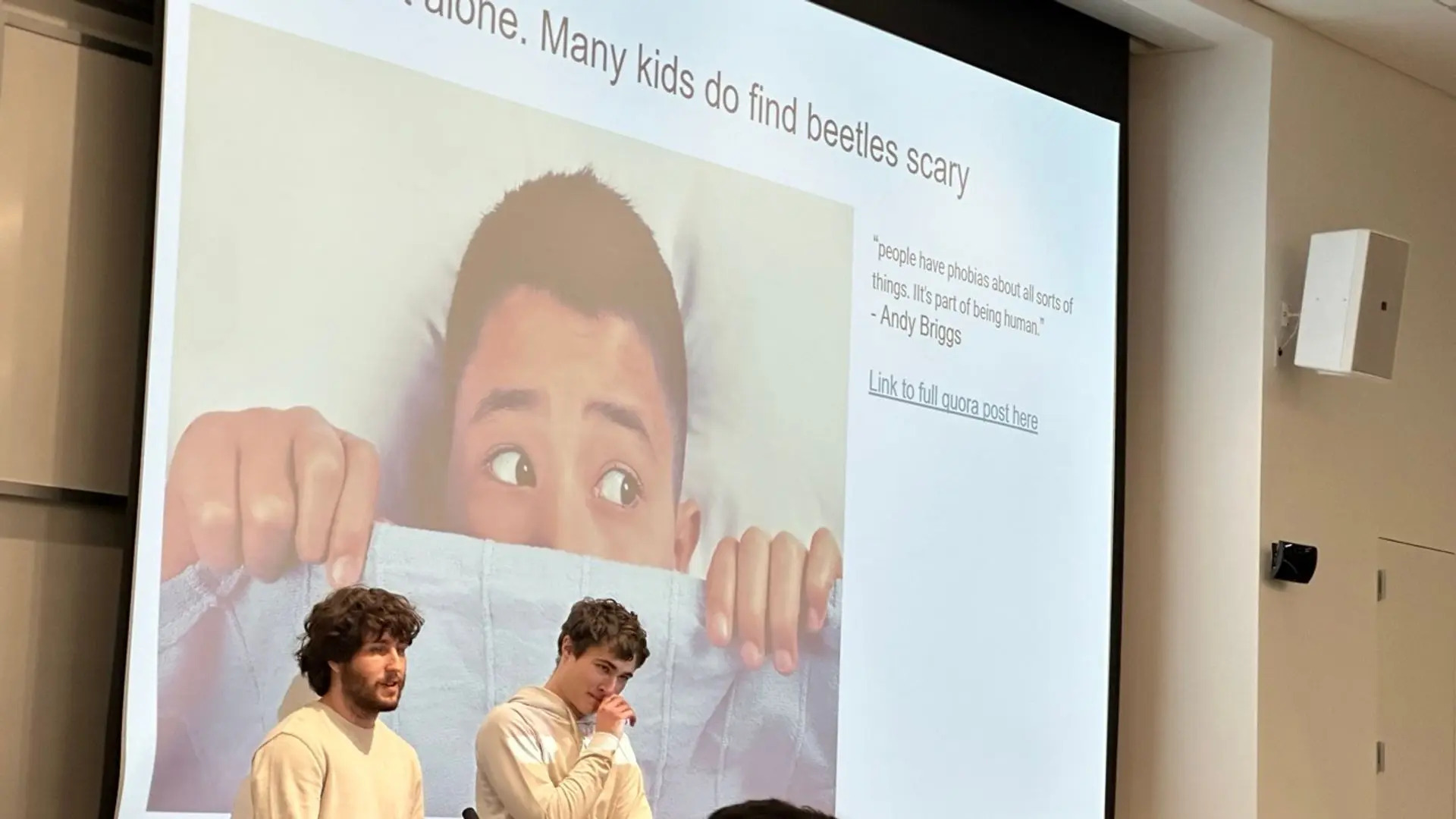 Two presenters in the midst of presenting an odd slideshow