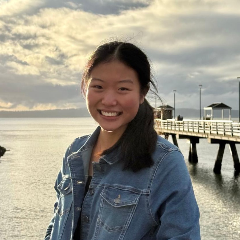 Brianna Ong smiling in front of a forest.
