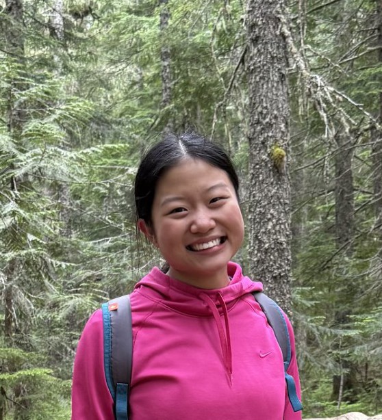 Brianna Ong smiling in front of a forest.